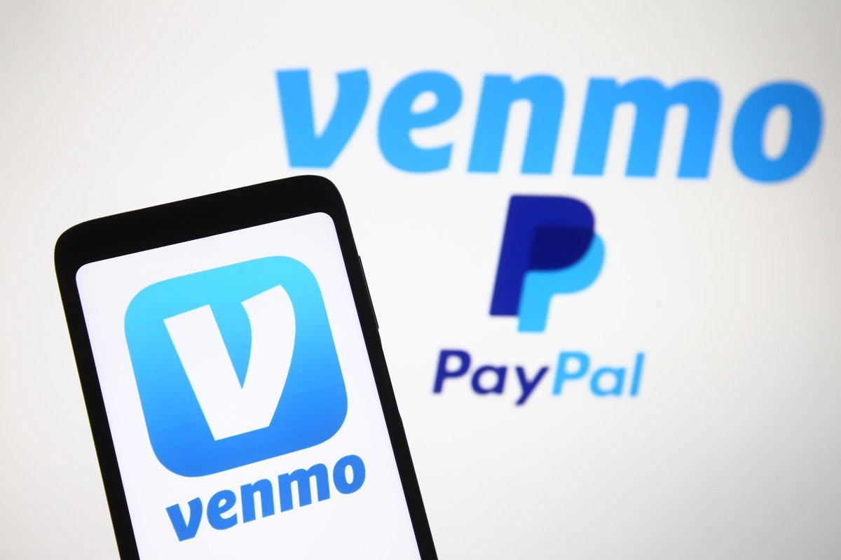 Venmo logo, a mobile payment service of PayPal is seen displayed on a smartphone and a PC screen.