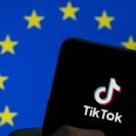 TikTok logo seen on an Android mobile device screen with the European Union (EU) flag in the background.