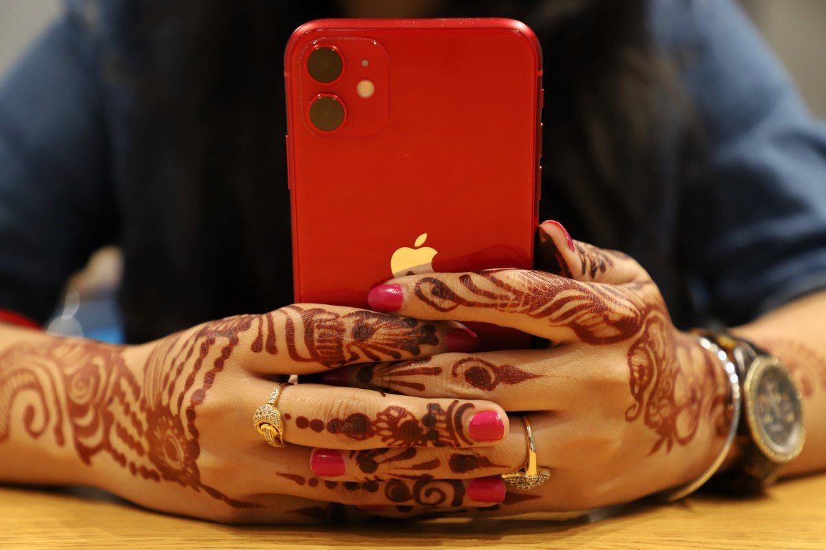 red iPhone held in two hands
