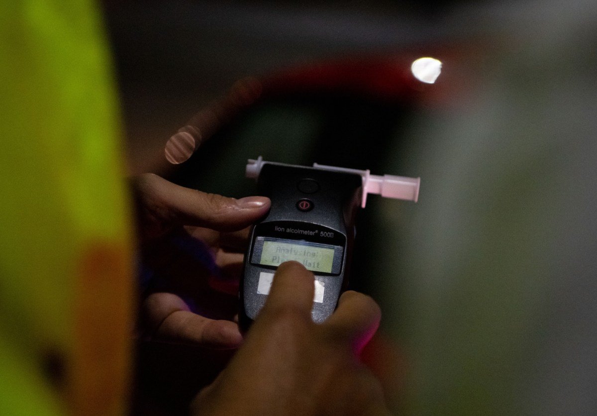 A police officer administers a breathalyser breath alcohol test after stopping a driver, on December 02, 2022 in Bournemouth, England.