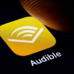 In this photo illustration the logo of Amazon Audible is displayed on a smartphone