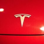 A Tesla logo seen on a Tesla Model 3 car.