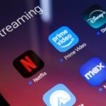 The streaming services Netflix, Amazon Prime Video, Disney Plus, Paramount Plus, Max, and Discovery Plus app appear on the screen of a smartphone