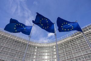 Flags of Europe as seen waving from the flagpoles in front of the EU Commission headquarters.