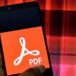In this Photo illustration an Adobe PDF logo seen displayed on a Smartphone.