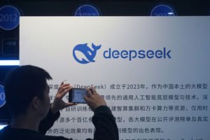 A man takes photos of a DeepSeek display at a shopping mall in Hangzhou