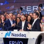 People applauding a new stock listing on the Nasdaq.