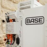 A Base Power battery sits next to a home.