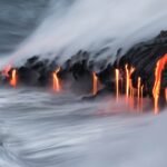 Lava pours into the ocean.