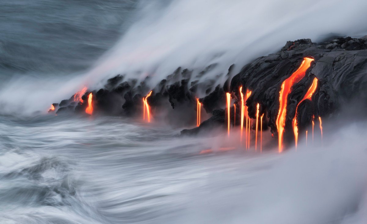 Lava pours into the ocean.