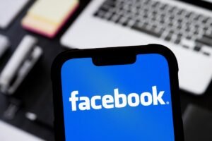 photo illustration of Facebook logo is seen displayed on a smartphone.