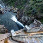 a photo of a dam in Spain seen spilling water.