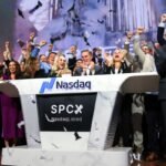 Bret Johnsen (C), SpaceX Chief Financial Officer, and Gwynne Shotwell (center R), SpaceX President and Chief Operating Officer, celebrate as they ring the opening bell at the Nasdaq MarketSite to celebrate the launch of SpaceX’s initial public offering (IPO) in New York on June 12, 2026.