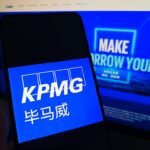 SUQIAN, CHINA - MAY 19, 2026 - A netizen is checking KPMG logo on his mobile phone and KPMG webpage on his computer in Suqian City, Jiangsu Province, China on May 19, 2026. (Photo credit should read CFOTO/Future Publishing via Getty Images)