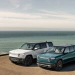 Two Rivian EVs parked by the ocean