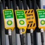 Signs warn drivers that gas pumps are out of order.