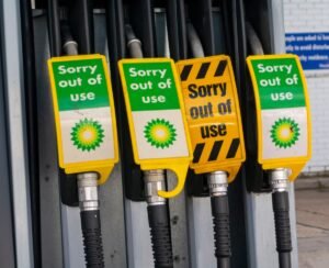 Signs warn drivers that gas pumps are out of order.